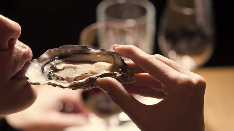 girl slurping on an oyster