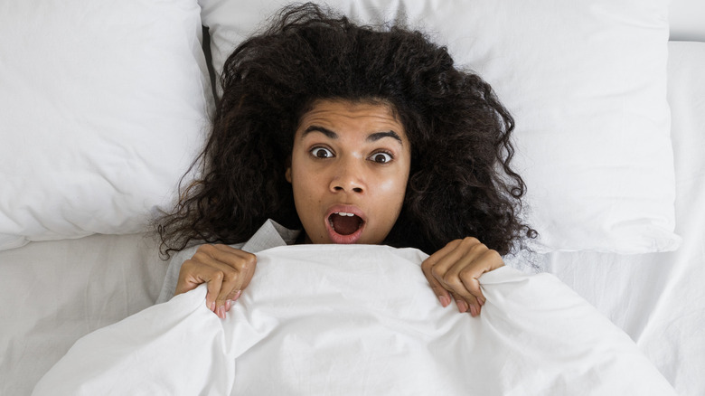woman in bed surprised