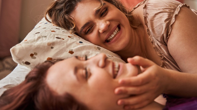 women smiling in bed