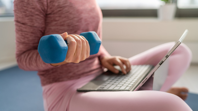 woman lifting weights while working