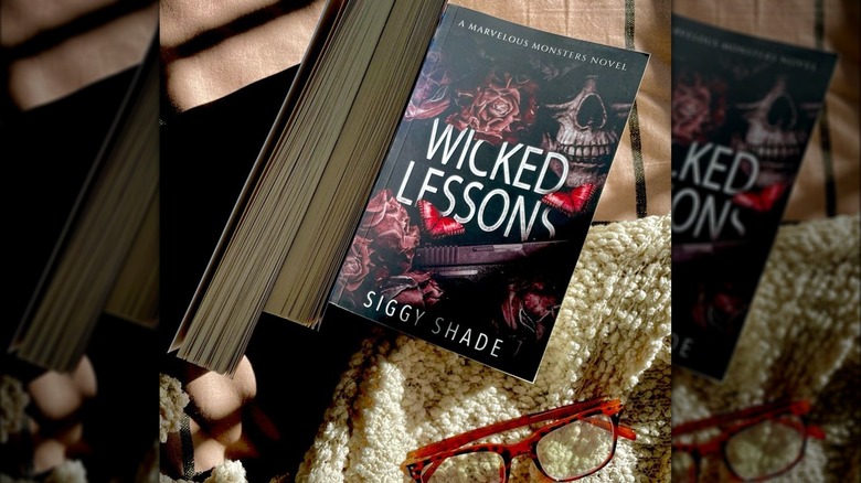 Wicked Lessons book and a pair of reading glasses