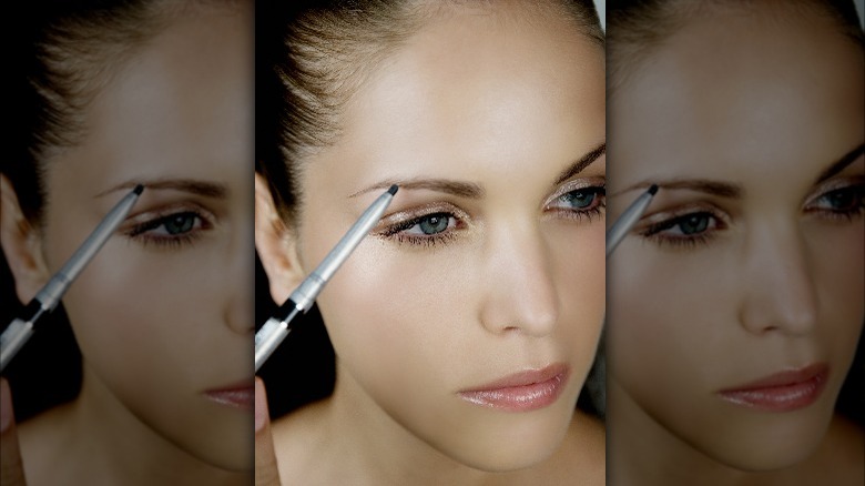 Woman filling in brow with pencil