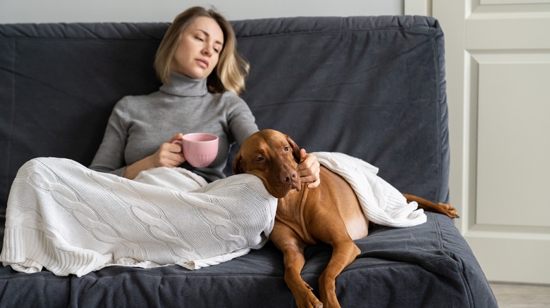 Lonely woman on couch with dog