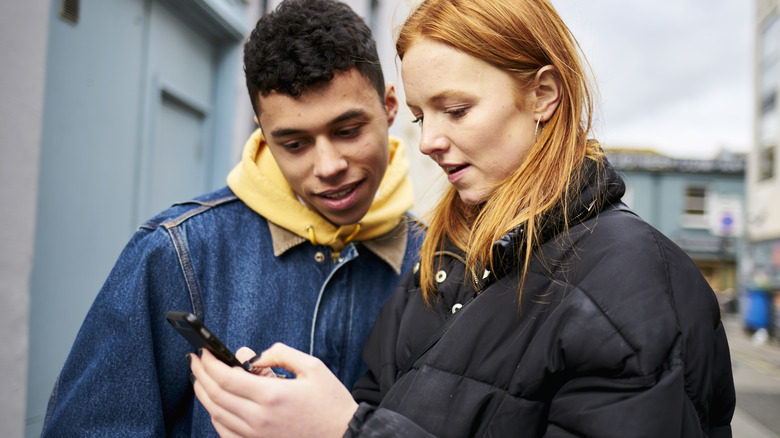 Couple looking at phone together