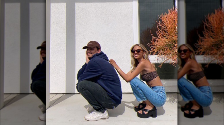 Man and woman squatting for picture