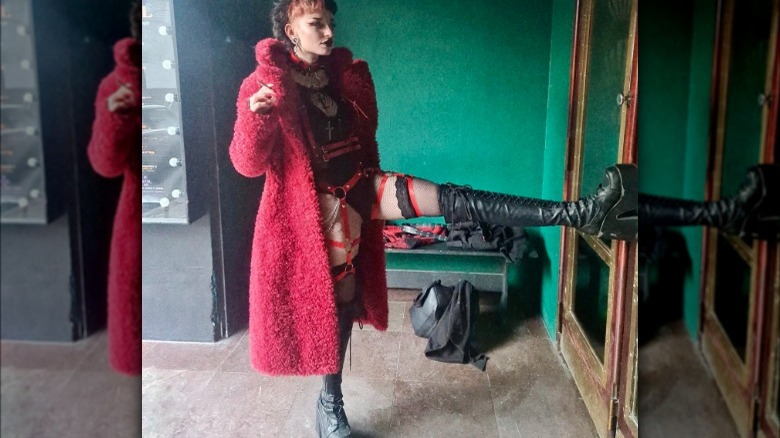 Thigh-high black boots and red coat