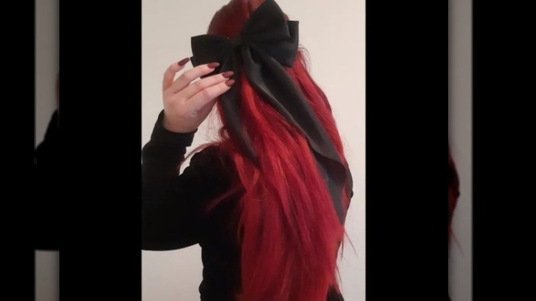 Redheaded woman with black bow
