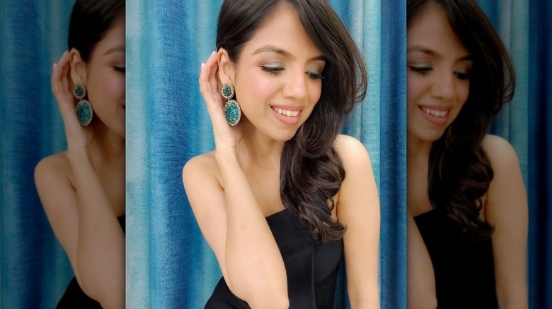 Woman showing off bold earrings