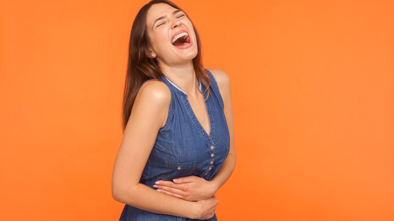 Woman belly laughing