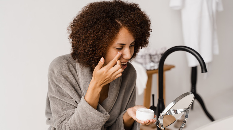 woman applying eye cream