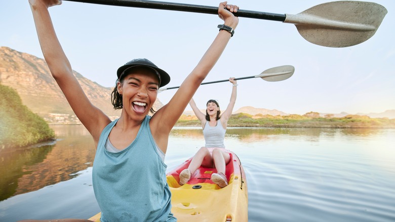 Smiling women on kayaks