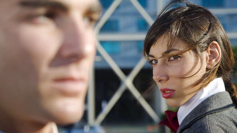 Business woman glaring at man