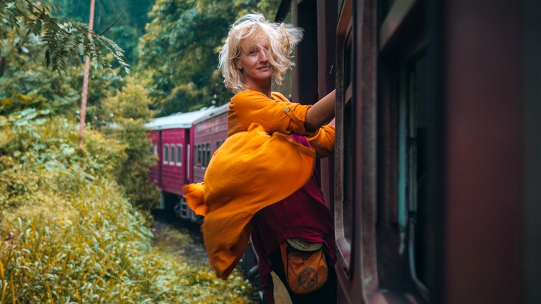 Woman leaning out of train car