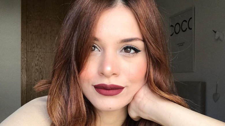 woman wearing burgundy lip color