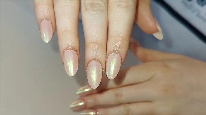 fingers with vanilla chrome nails 