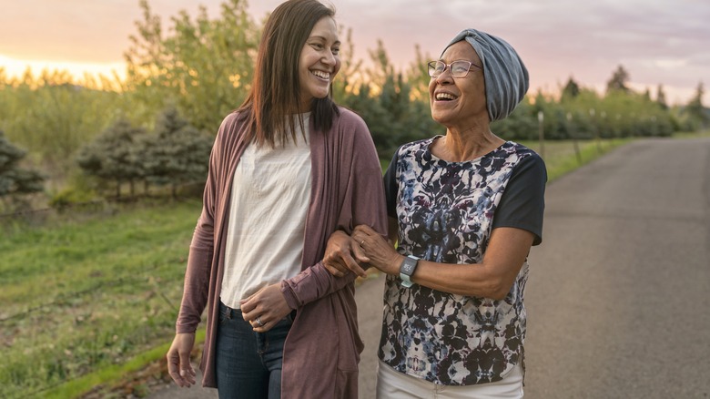 Woman assisting woman walking