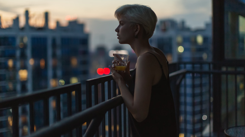 Woman on balcony at dusk