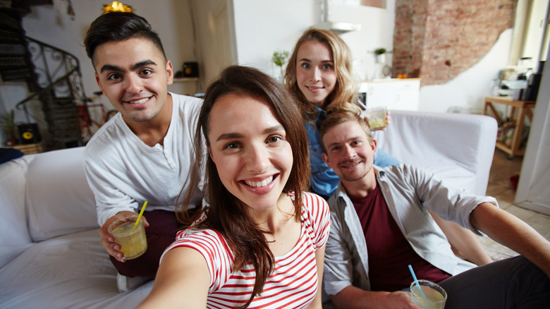 Woman taking selfie with partners 