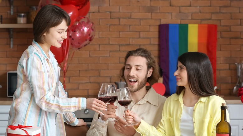 Man, two women doing toast