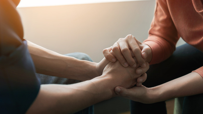 Two people holding hands