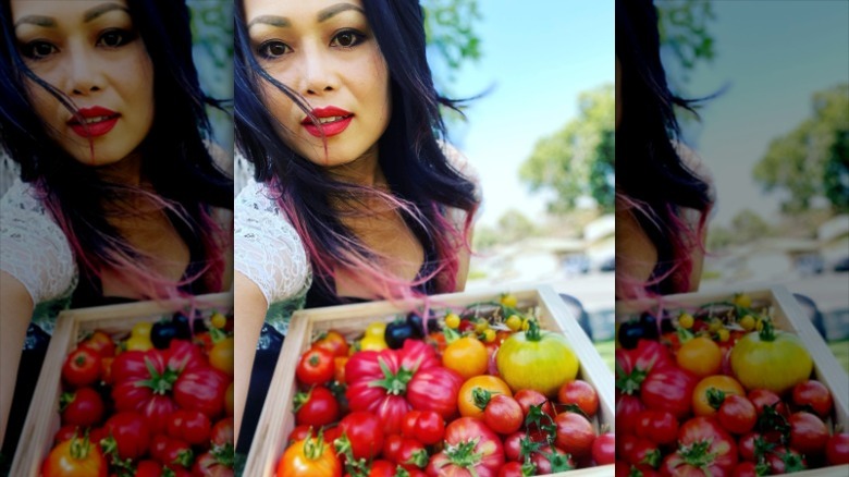 Woman posing with tomatoes