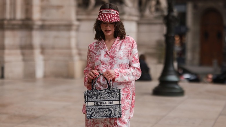 woman with Dior print visor