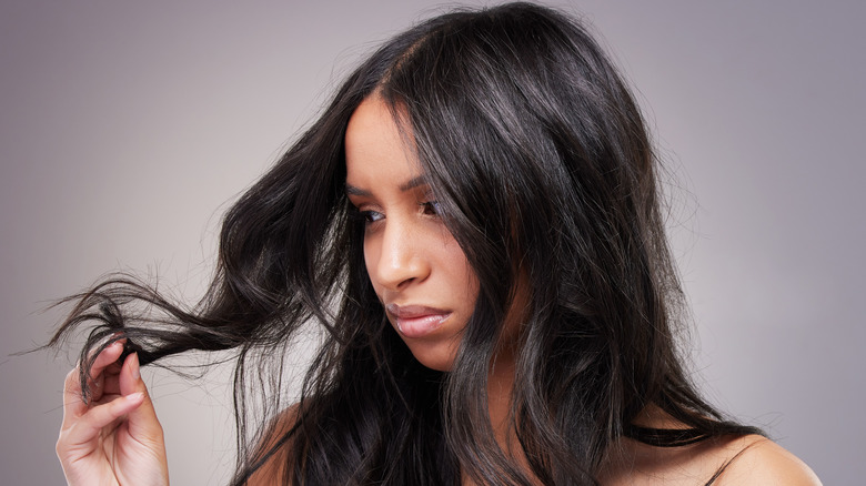 woman looking at split ends