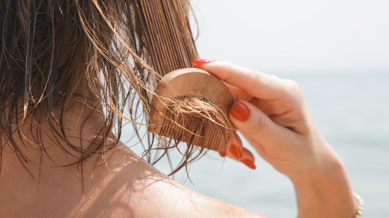 Woman combing hair 