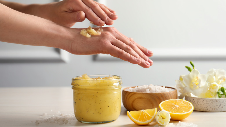 woman applying lemon scrub