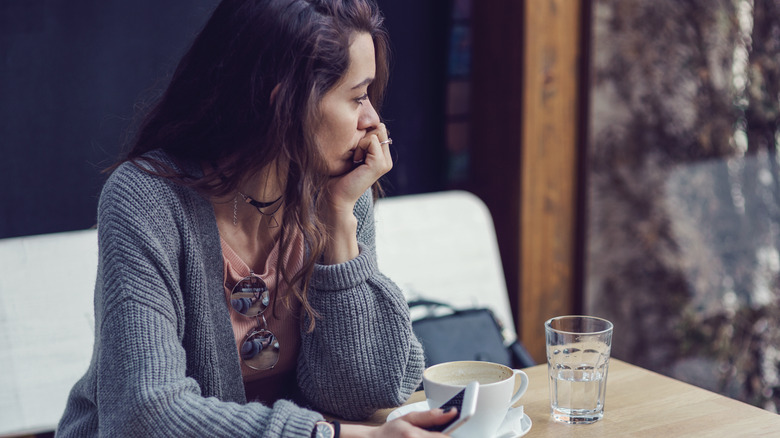 Sad woman with coffee