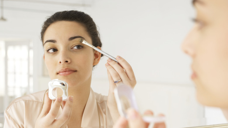 woman applying eyeshadow