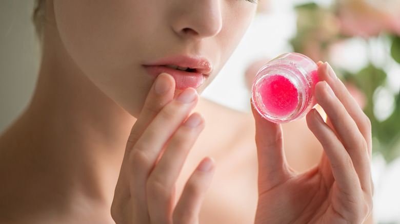 Woman applying a lip scrub