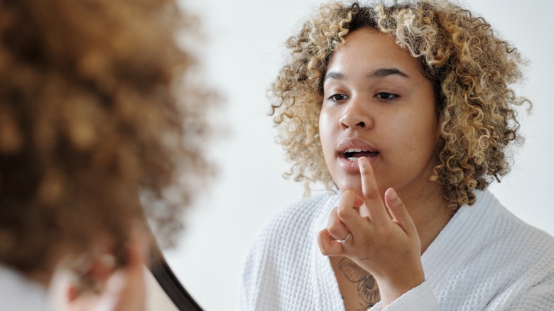 person touching their lip