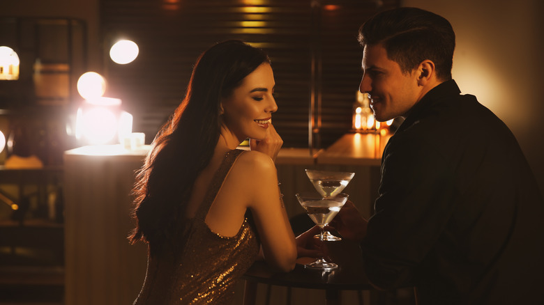 Man and woman having cocktails in restaurant