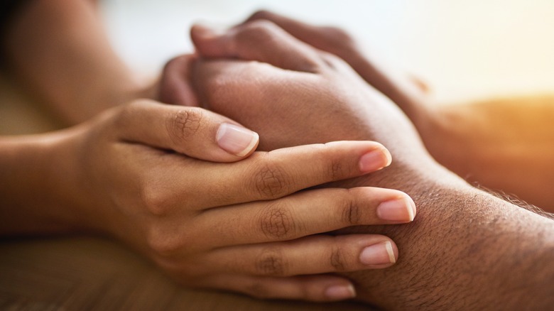 Couple holding hands comfort