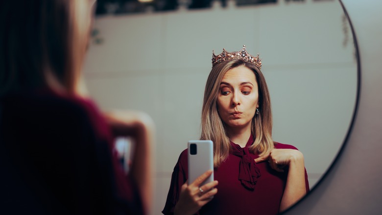 Narcisstic woman taking selfie crown