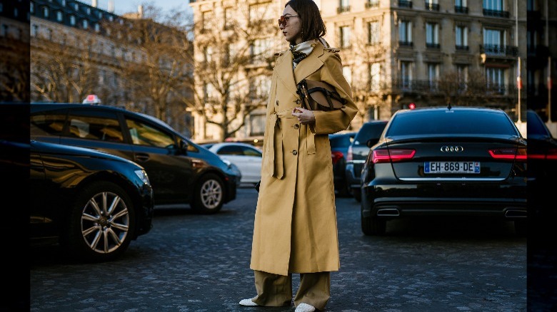 woman in amber yellow coat