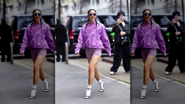 woman wearing purple jacket and shorts