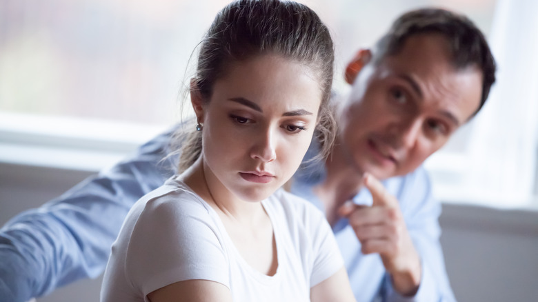 man yelling at upset woman