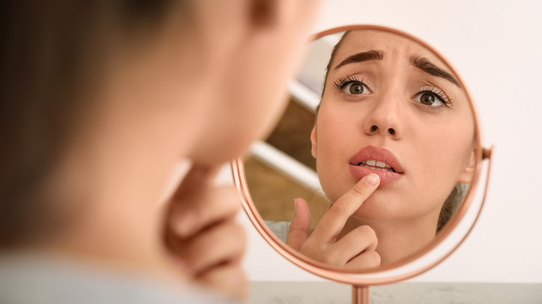 Woman looking at chapped lips