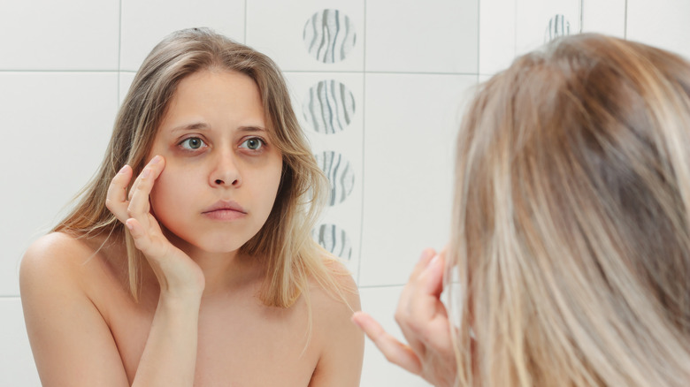 Woman looking at dark under-eye circles