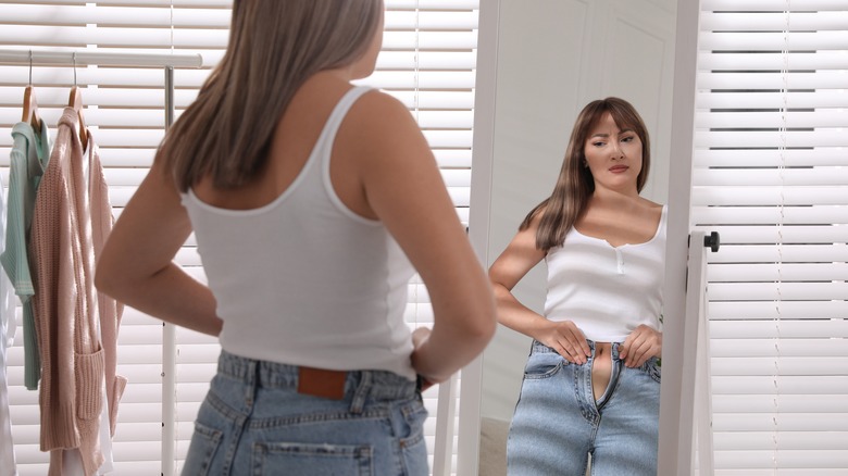 woman unhappy because jeans don't fit