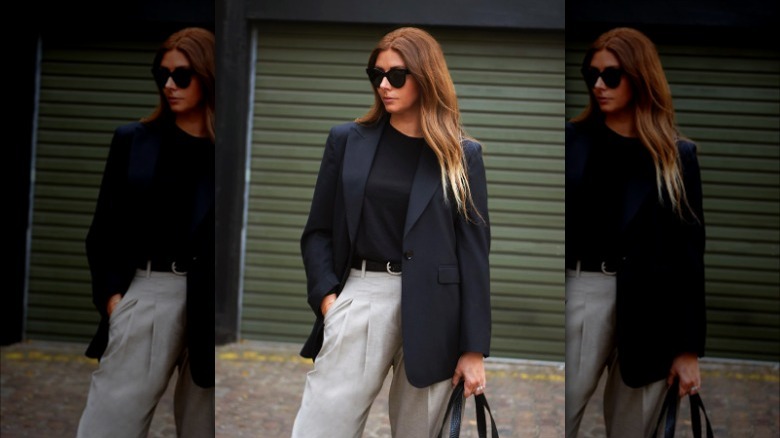 woman with black blazer, washed black shirt, and khaki slacks