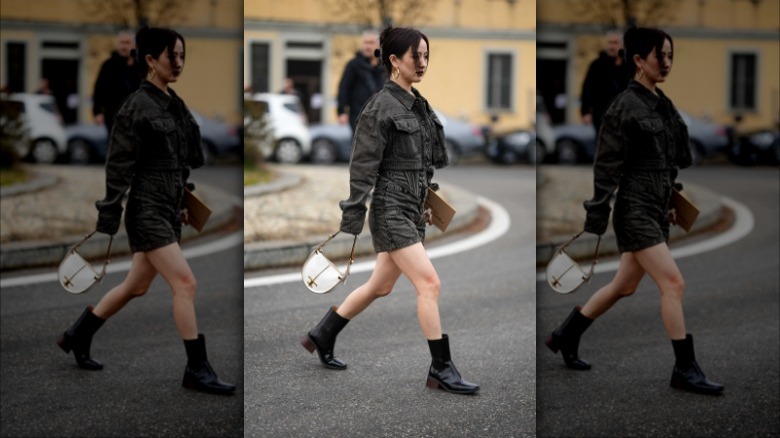 woman wearing matching black denim jacket and shorts