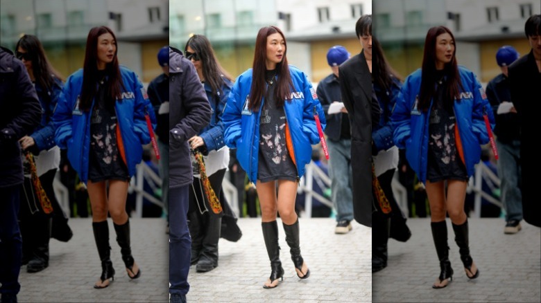 woman with blue bomber jacket and washed black graphic tee