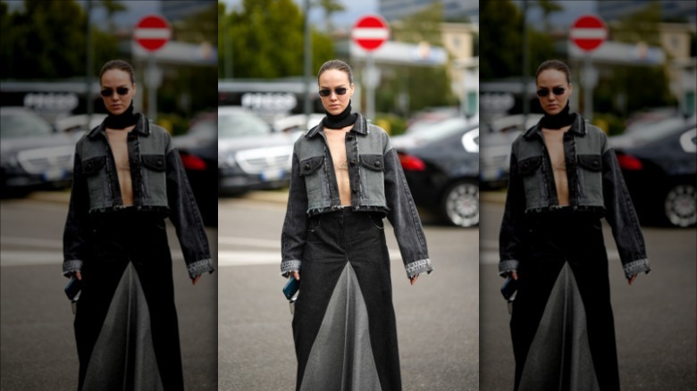 woman with cropped washed black denim jacket and skirt