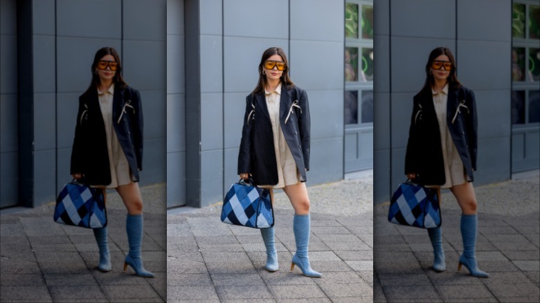 woman wearing denim patched tote