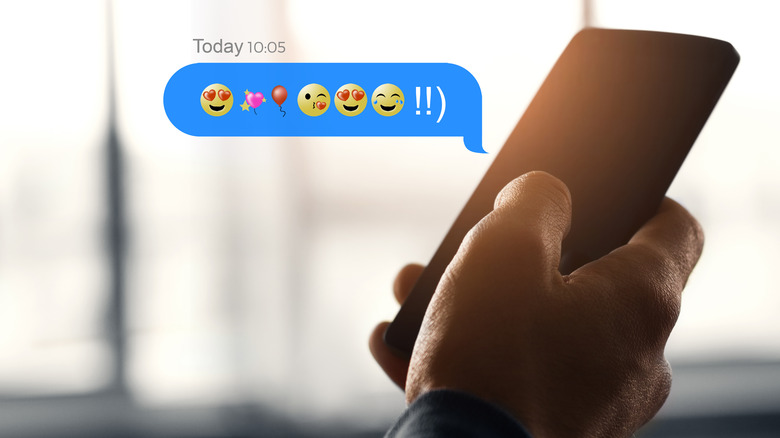 person holding phone with emojis