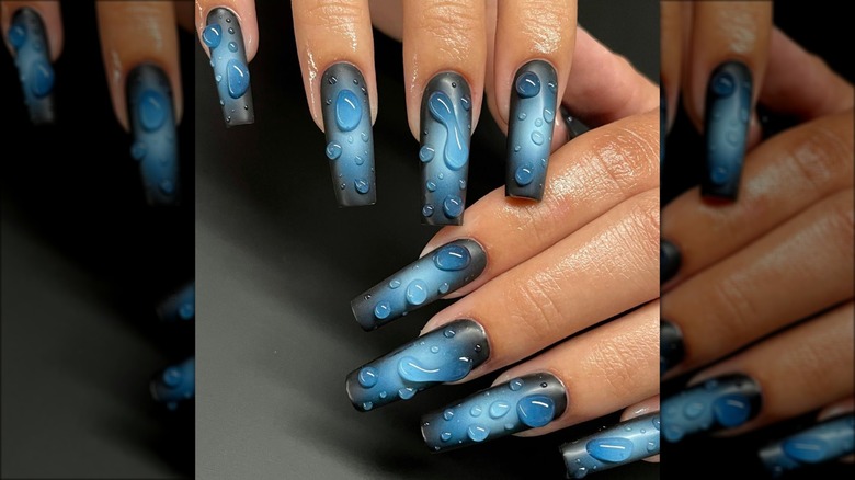 black and blue nails with water droplets