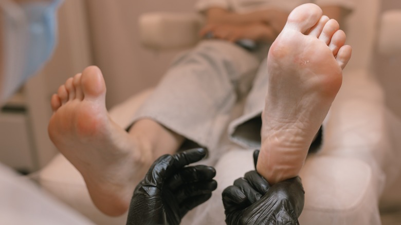 podiatrist checking client's feet